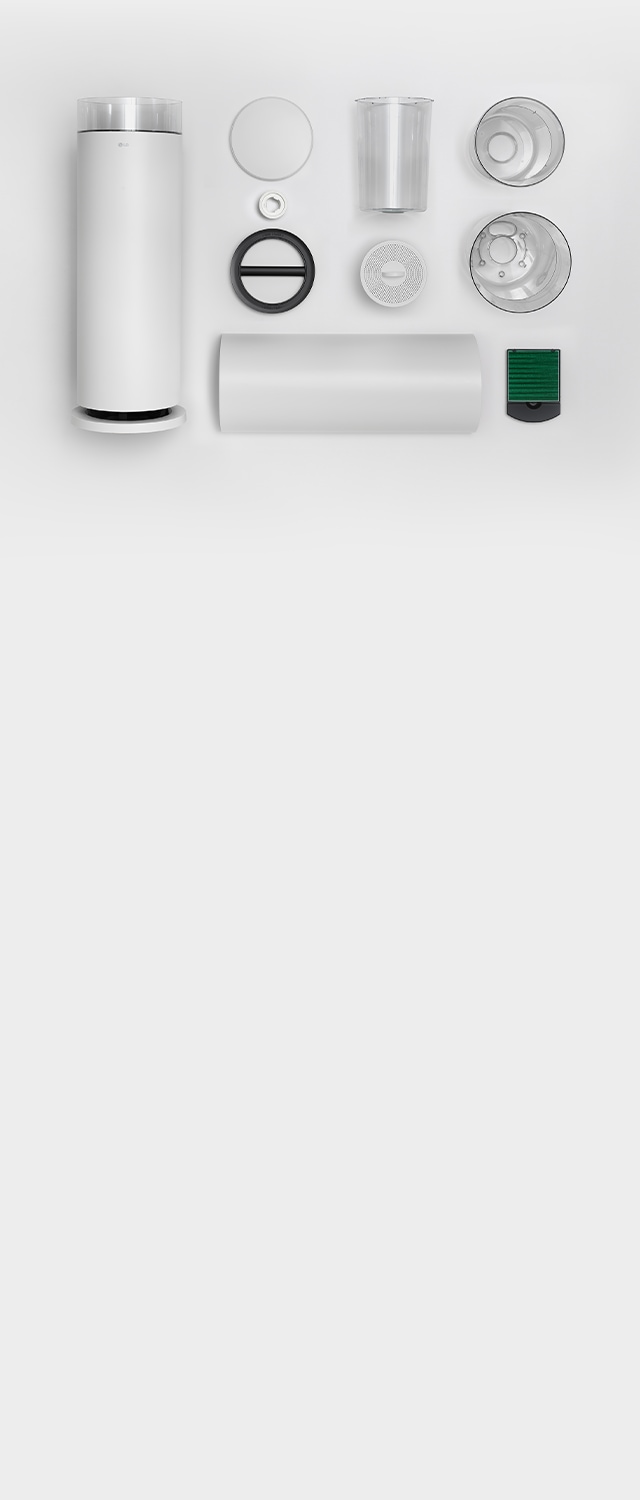 LG 퓨리케어 오브제컬렉션 하이드로에센셜 제품의 다양한 부품들이 분해되어 배열되어 있습니다. 원통형 본체, 둥근 뚜껑, 투명한 물통, 두 개의 원형 필터, 금속 재질과 투명한 플라스틱 재질의 부품들이 함께 놓여 있습니다.