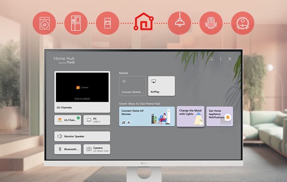LG 스마트모니터 화면에 Home Hub powered by ThinQ라는 제목과 함께 다양한 기능이 표시되어 있습니다. 화면 왼쪽에는 LG Channels라는 텍스트와 함께 Click to Watch라는 버튼이 있으며, 그 아래에는 LG Channels, PC USB C, Monitor Speaker, Bluetooth, Camera LG Smart Cam이라는 항목들이 나열되어 있습니다. 오른쪽 상단에는 Mobile 섹션이 있으며, Connect Mobile..과 AirPlay 버튼이 있습니다. 그 아래에는 Smart Ways to Use Home Hub라는 제목과 함께 Connect Home IoT Devices, Change the Mood with Lights, Get Home Appliance Notifications라는 세 가지 옵션이 나열되어 있습니다. 모니터 위쪽에는 빨간색 아이콘들이 나열되어 있으며, 각각의 아이콘은 스마트홈 기기를 상징하는 이미지로 구성되어 있습니다. 모니터는 밝은 실내 공간에 배치되어 있으며, 창문을 통해 자연광이 들어오는 모습입니다.