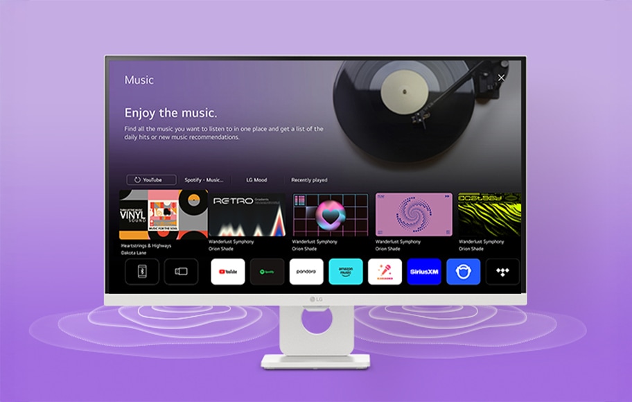 모니터 화면에는 'Music'이라는 제목과 함께 'Enjoy the music.'라는 문구가 있습니다. 'Find all the music you want to listen to in one place and get a list of the daily hits or new music recommendations.'라는 설명이 이어집니다. 화면에는 YouTube, Spotify, LG Mood 등의 옵션이 있으며, 'Recently played' 섹션에는 다양한 앨범 커버 이미지가 나열되어 있습니다. 배경에는 보라색 그라데이션이 사용