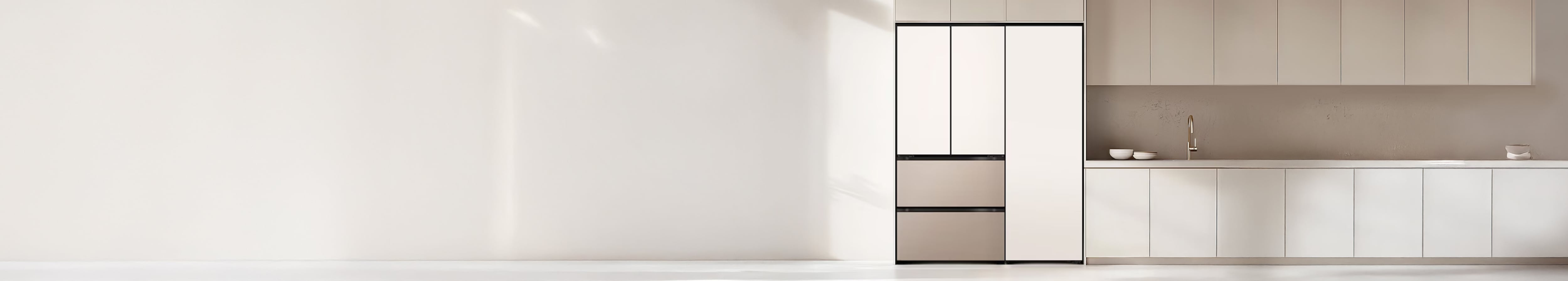 부드러운 베이지 톤과 화이트가 조화를 이루는 미니멀한 주방 공간으로, 왼쪽에는 매트 화이트 도어와 메탈릭 베이지 서랍이 조합된 빌트인 김치냉장고가 설치되어 있습니다. 오른쪽에는 동일한 톤의 하부장과 상부장이 일체감 있게 구성되어 있으며, 조리대 위에는 화이트 그릇이 간결하게 배치되어 있습니다.