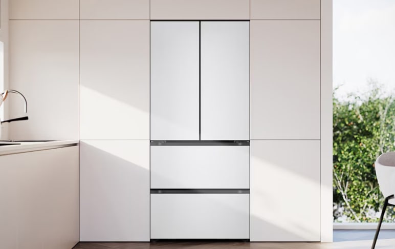 매트 화이트 컬러의 프렌치도어 김치냉장고가 빌트인 형태로 모던한 주방에 설치되어 있습니다. 상하 수납장과 동일한 톤으로 매끄럽게 어우러져 일체형 디자인을 완성하며, 창가로 스며드는 햇빛과 조화를 이루어 밝고 깔끔한 분위기를 연출합니다.