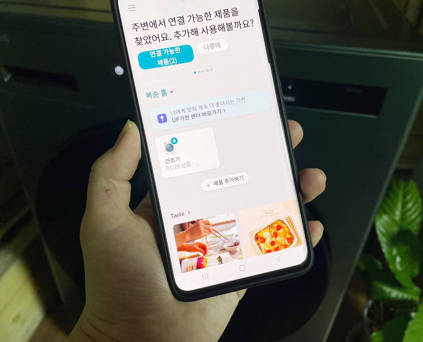 스마트폰 화면에 LG 트롬 오브제컬렉션 건조기가 연결된 상태로 제품을 설정하는 UI가 표시된 모습.