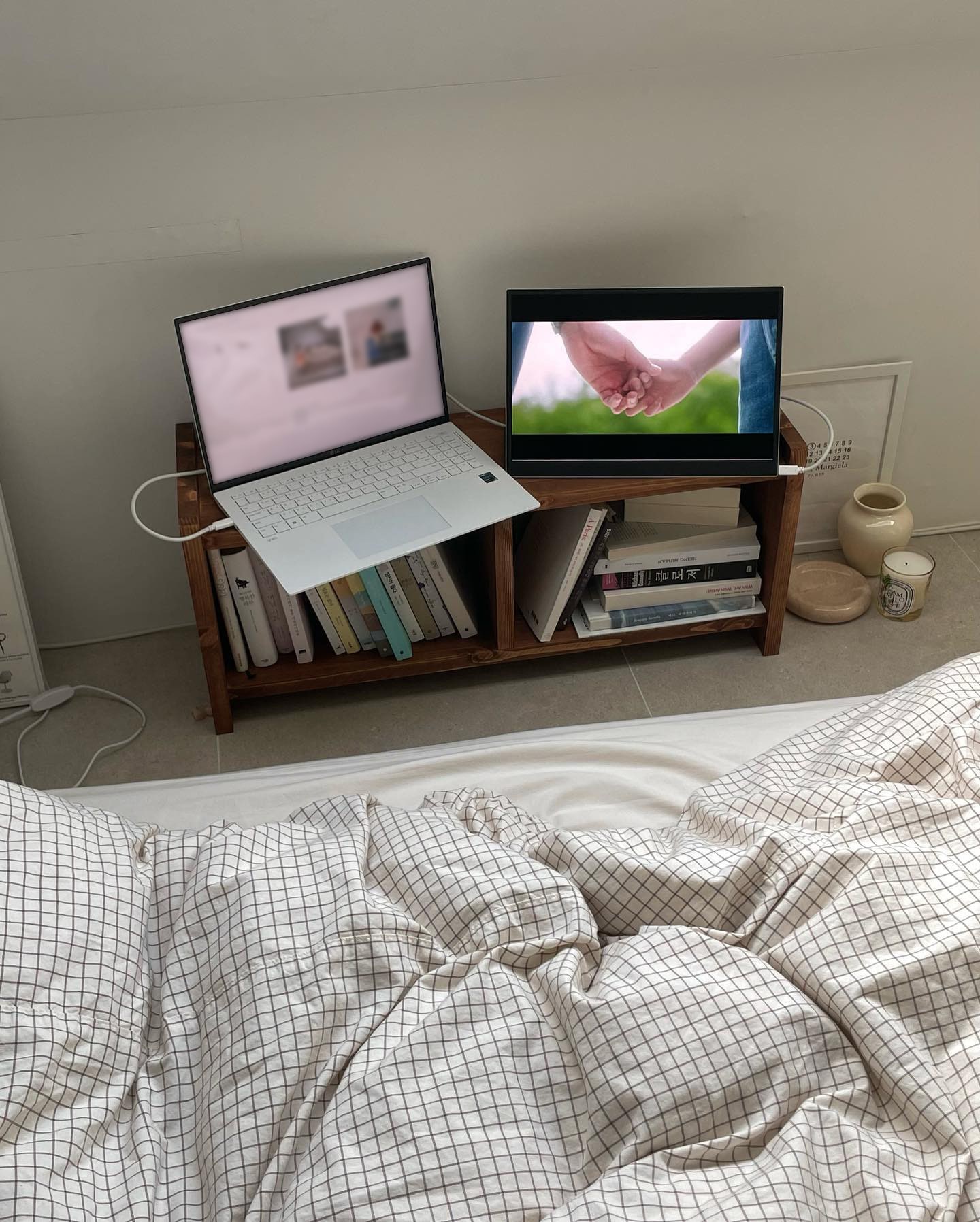 침대 맞은편 책장 위에 놓인 노트북과 LG 그램 +view 듀얼 모니터, 따뜻하고 아늑한 침실 분위기