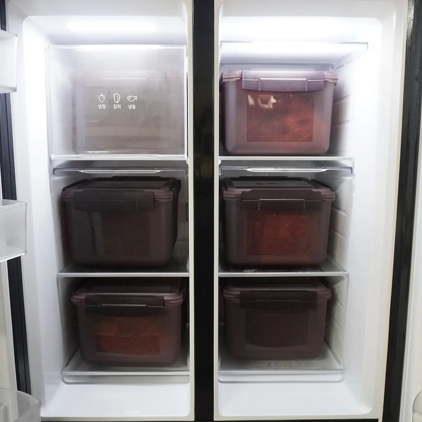 LG 디오스 오브제컬렉션 김치톡톡 냉장고 내부에 김치 저장 용기가 깔끔하게 정리된 모습.
