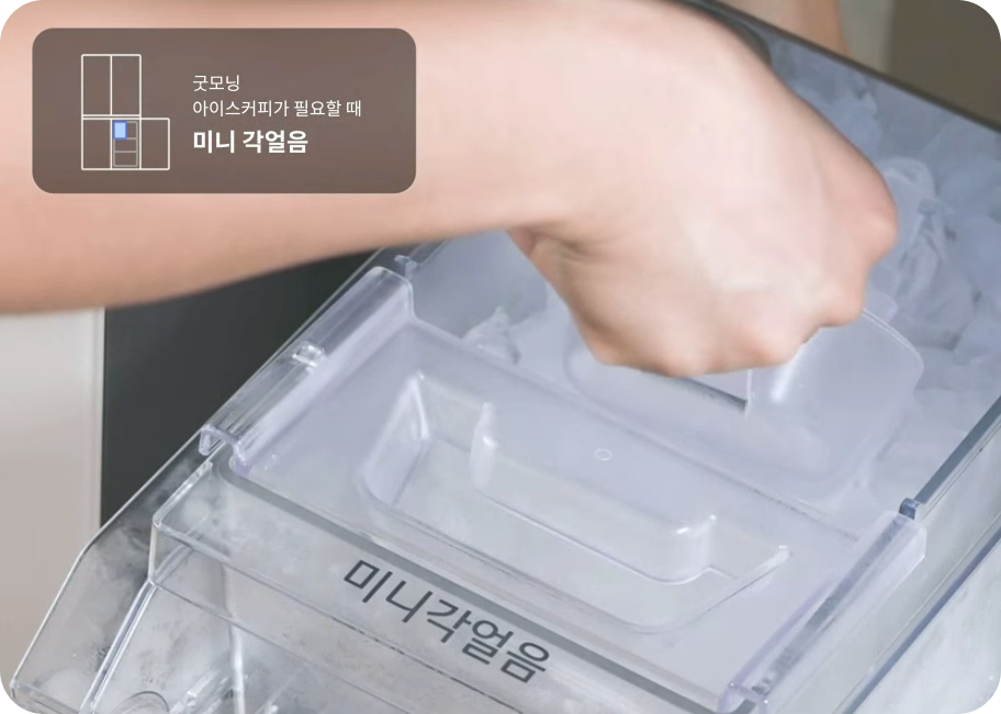 냉동실 서랍 안에서 작은 사이즈의 사각형 얼음을 스쿱으로 푸고 있는 모습입니다. 투명한 얼음 통에는 '미니 각얼음'이라고 적혀 있으며, 상단에는 