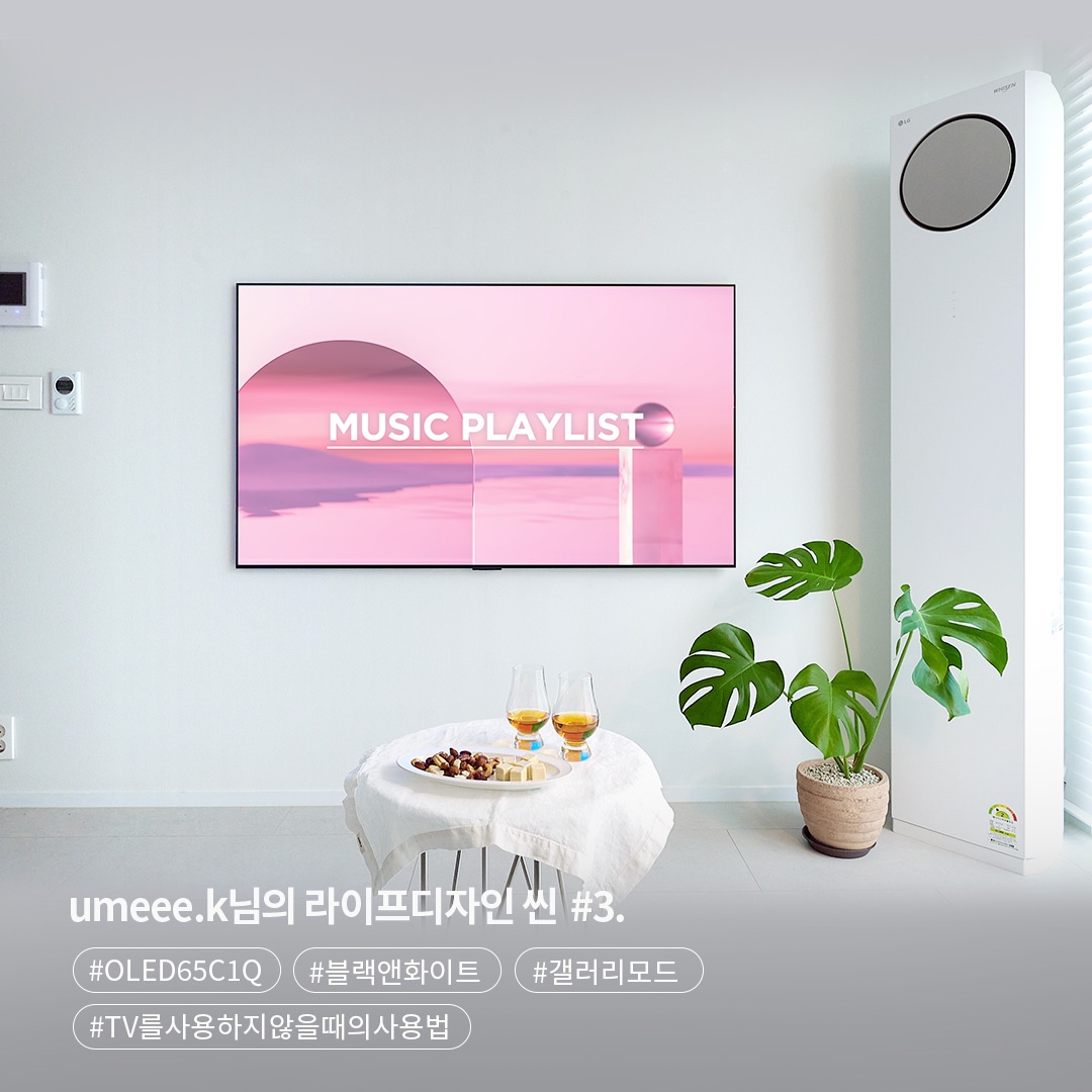 벽걸이 TV가 흰 벽에 설치되어 있으며, 화면에는 