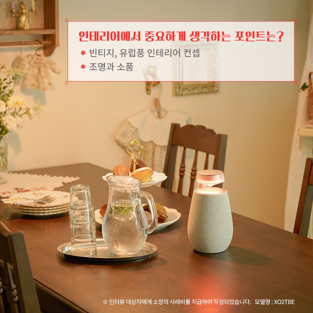 인테리어에서 중요하게 생각하는 포인트는? 빈티지, 유럽풍 인테리어 콘셉 조명과 소품 ※ 인터뷰 대상자에게 소정의 사례비를 지급하여 작성되었습니다. 모델명: XO2TBE 문구 표시됨. 배경은 우드톤 식탁 위에 유럽풍 티 세트와 디저트가 놓여 있음. 벽에는 빈티지 소품과 장식이 배치되어 따뜻한 분위기를 연출하며, 블루투스 스피커가 감성을 더함.