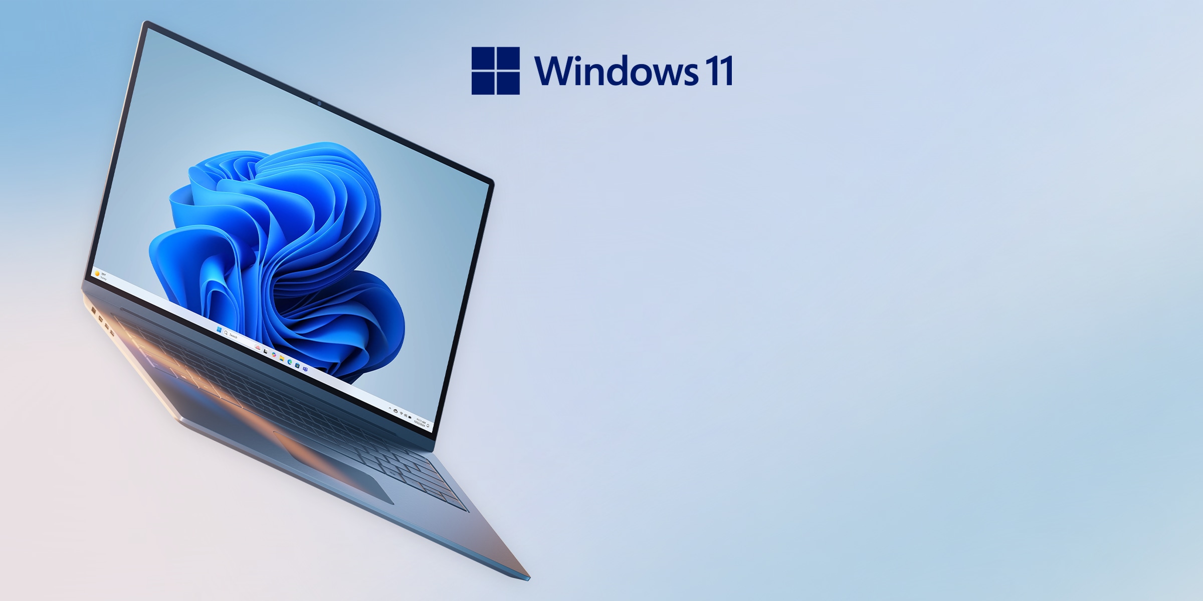 푸른색 그러데이션 배경 위에 Windows 11 로고와 함께 얇고 세련된 노트북이 비스듬히 놓여 있는 모습. 최신 Windows 11이 탑재된 제품임을 강조함.