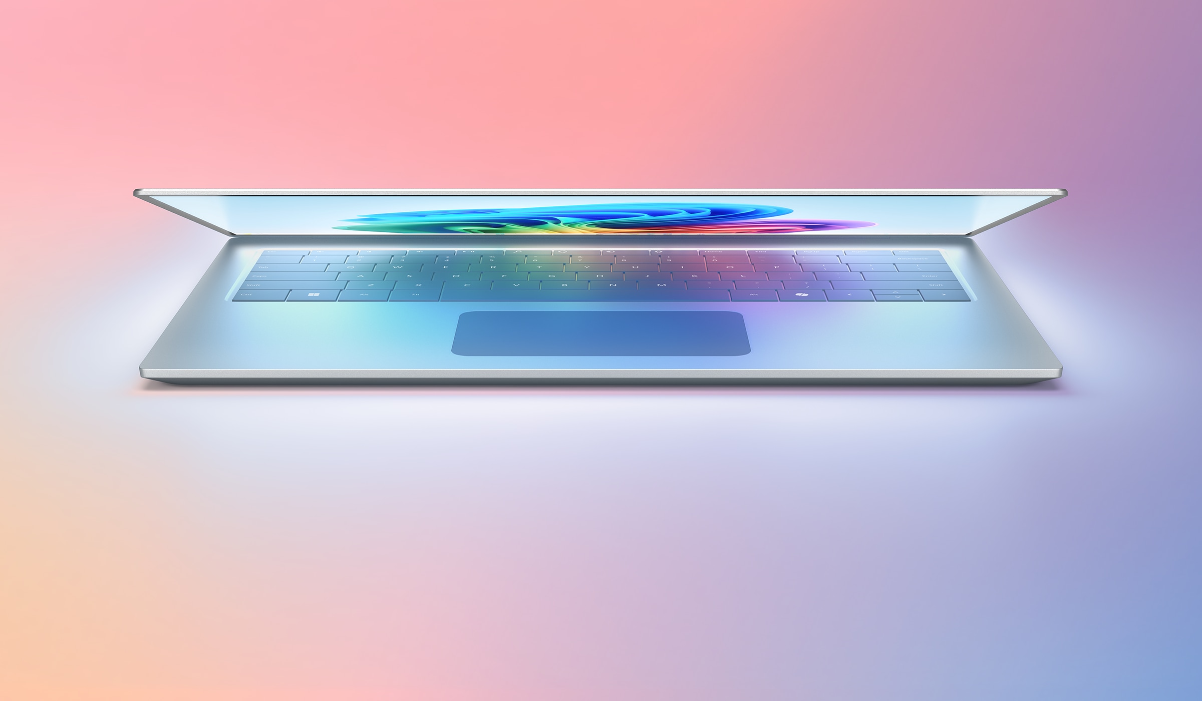 화려한 그라데이션 배경 위에 반쯤 열린 노트북이 중앙에 위치한 이미지. 화면에는 추상적인 컬러 패턴이 나타나 있음.