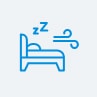 숙면 환경을 나타내는 파란색 아이콘으로, 침대와 베개, 공기 흐름 표시선, 'zzz' 텍스트가 포함된 그림.