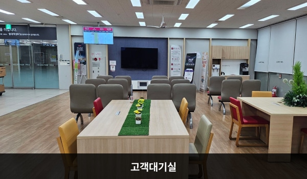 홍대역서비스센터의 현관문을 열고 안쪽으로 들어오시면 좌측에 앉아서 대기하실 수 있는 의자가 마련되어 있습니다. 의자와 마주 보는 쪽 벽면에 셀프바와 정수기가 있습니다.