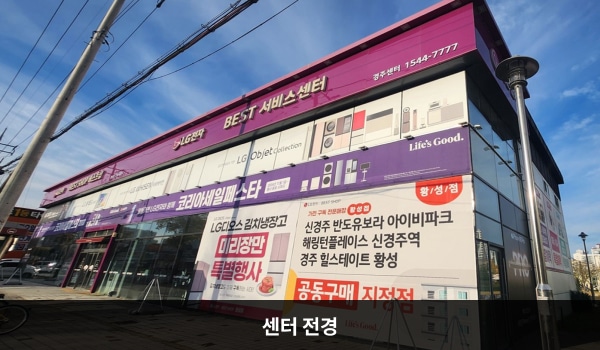 경주서비스센터의 서비스센터 건물은 가로로 길고 유리창이 많습니다. 건물 위쪽 간판에 흰색 글씨, 분홍색 바탕으로 'LG전자 BEST SHOP 베스트샵', 'BEST 서비스센터'라고 쓰여 있습니다.
