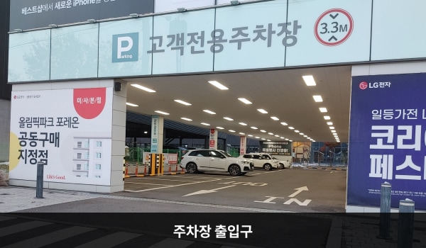 미사본점서비스센터의 건물 1층이 주차장입니다. 주차장 출입구는 건물 정면 좌측에 있습니다. 출입구 위에는 '고객전용주차장'이라고 적혀 있으며, 차량 제한 높이는 3.3m입니다.