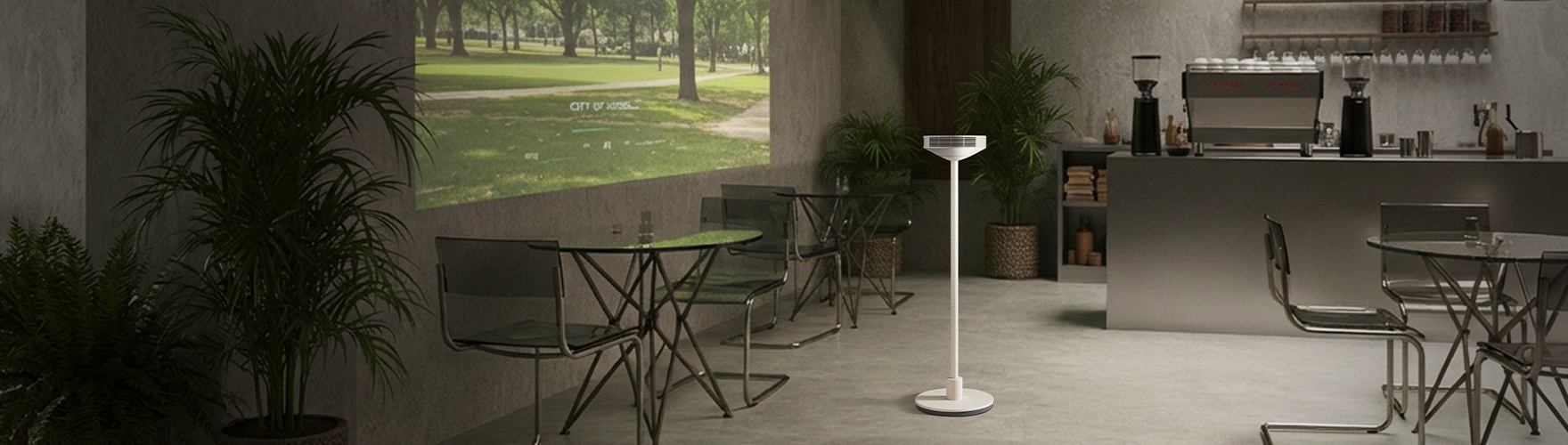 카페 같은 실내 공간 한가운데 LG 무드메이트가 놓여 있고, 왼쪽 벽면에는 공원 풍경 영상이 투사되어 있습니다. 오른쪽에는 커피머신과 선반이 배치되어 있습니다.