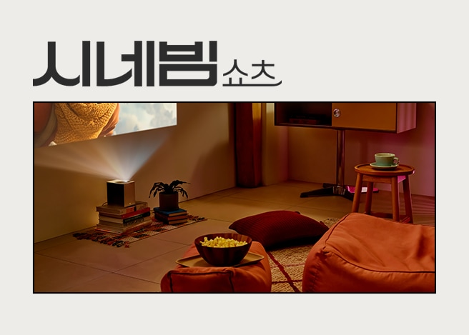 좌측 벽 아래 시네빔 쇼츠가 놓여있고 벽면에는 영화가 나오고, 우측 쇼파와 팝콘이 배치되어 있습니다 