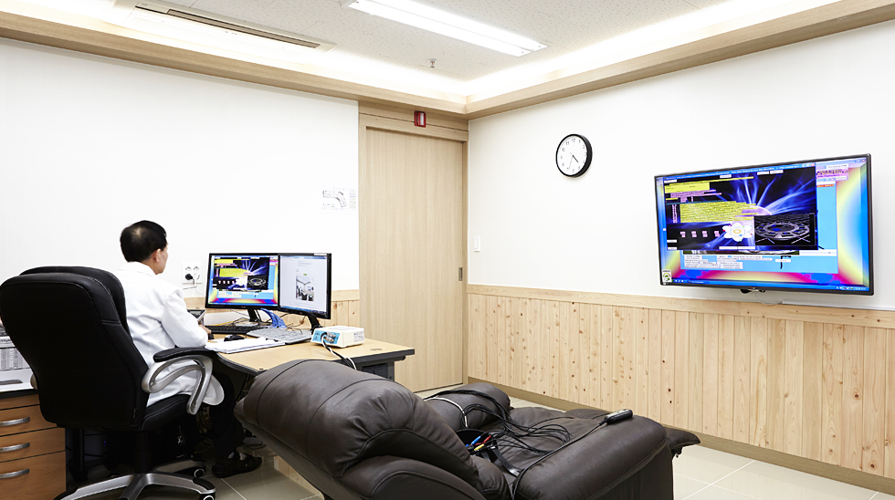 복잡한 의료기기를 커머셜 TV와 연결해 치료에 활용하고 있는 양자파동의학실의 모습.